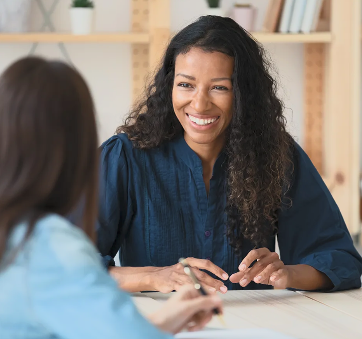 Therapist meeting with a client in a warm, professional setting
